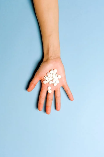 pills on a person's hand