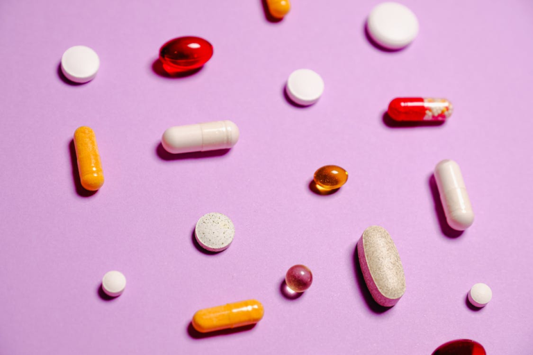 A close-up of red, white, and yellow medication pills