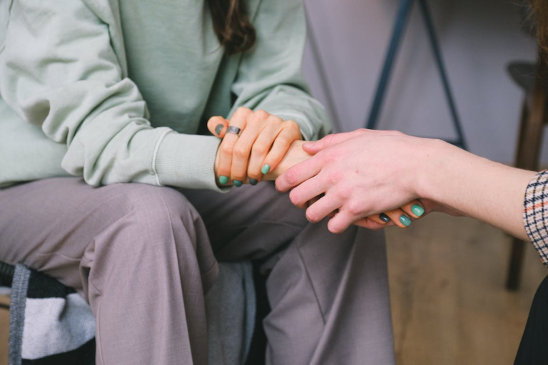 A therapist holding a patient's hand