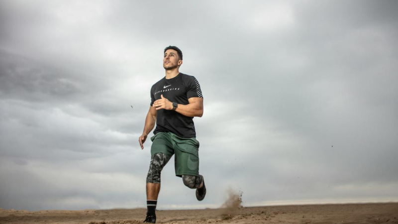 A man running on a sandy ground