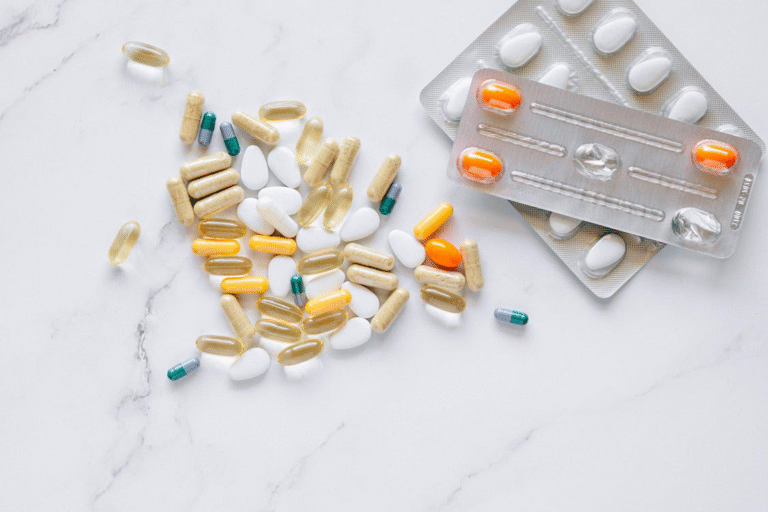 An image of pills and packs of pills on a white background