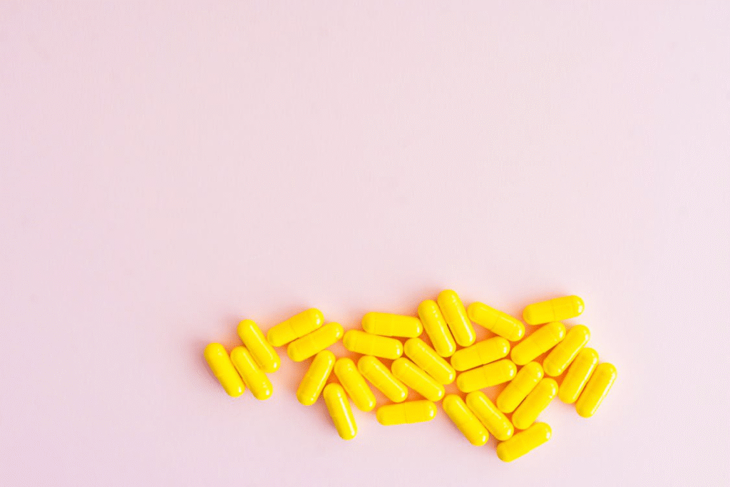 An image of pills on a pink background