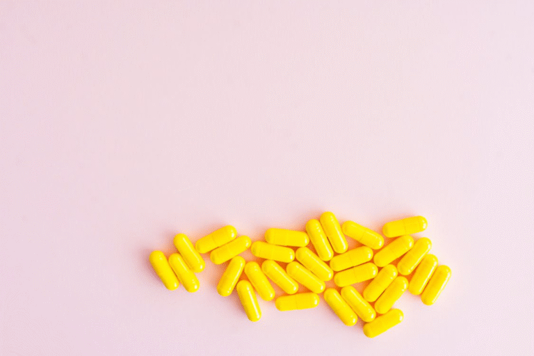 An image of pills on a pink background