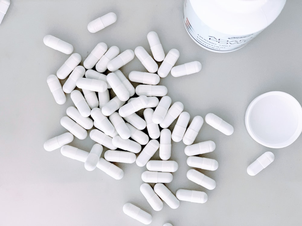 An image of white pills and a pill box   