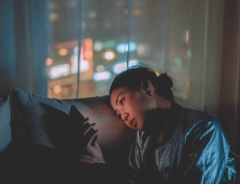 A person using their phone in the dark