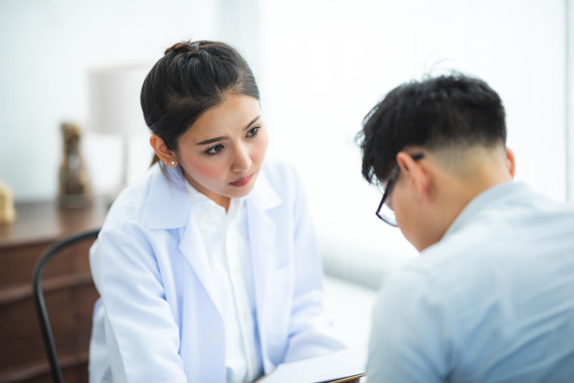 An image of a woman in a white coat   