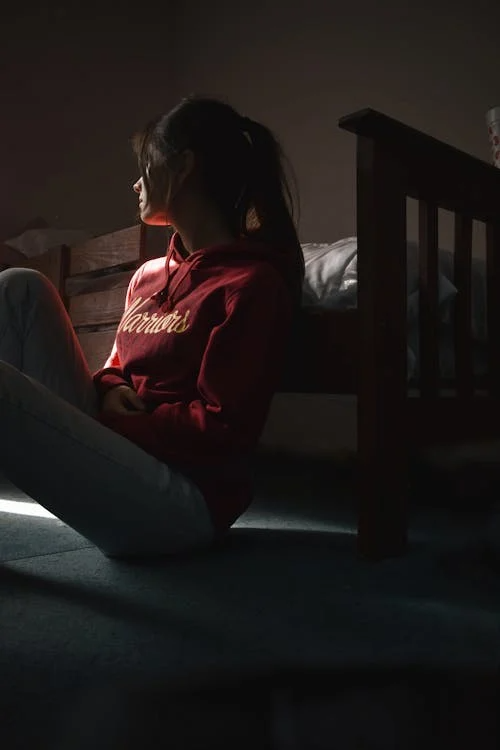A sad person sitting on the floor