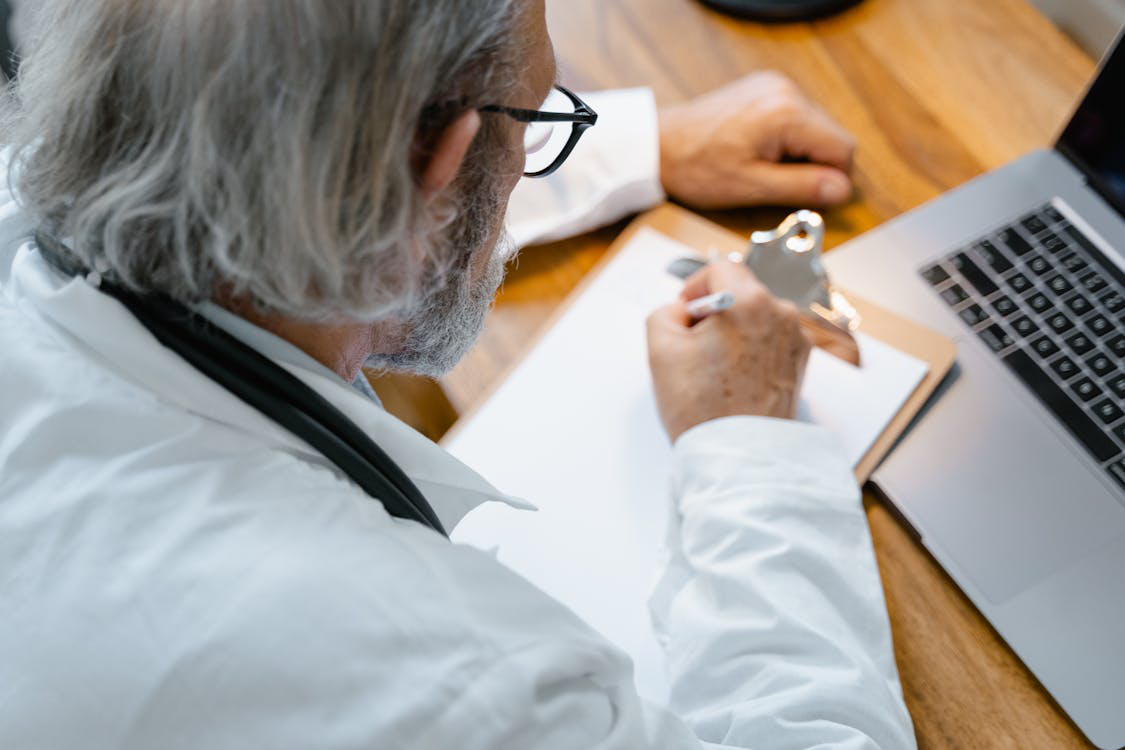 An image of a person writing something on paper
