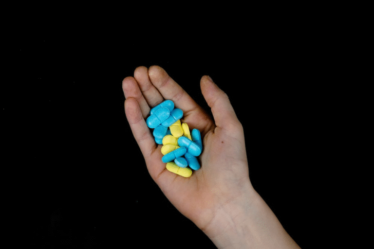 An image of pills in a person’s hand