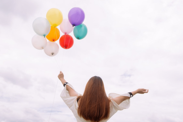 A person holding balloons