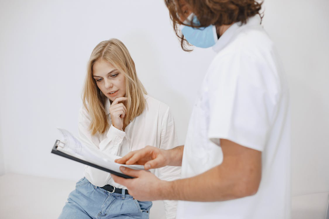 An image of a woman and another person looking at some papers    