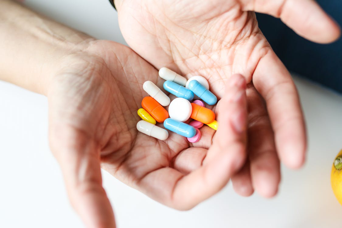 An image of pills in a person’s hand    