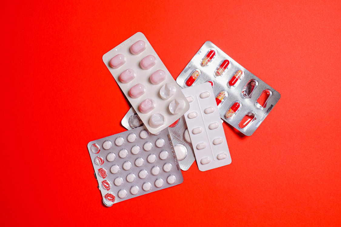 An image of pills on a red background 