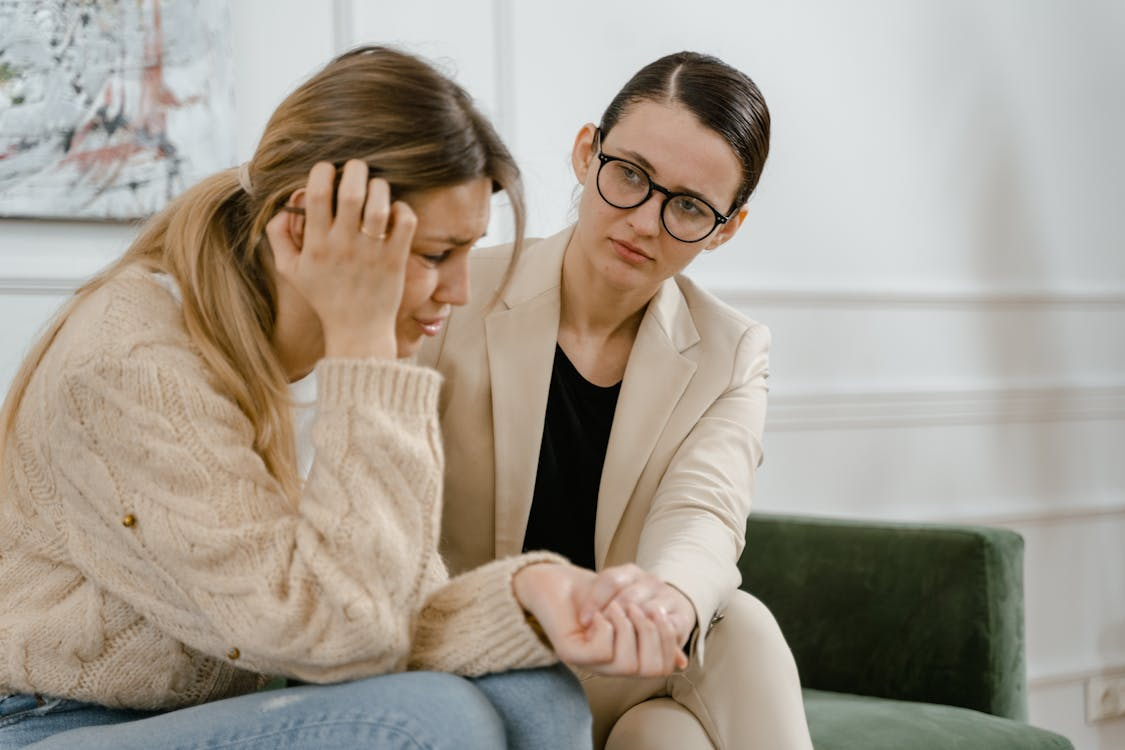 A therapist comforting a person