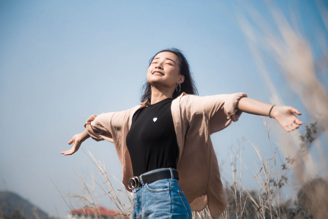 A person smiling and basking in the sunlight