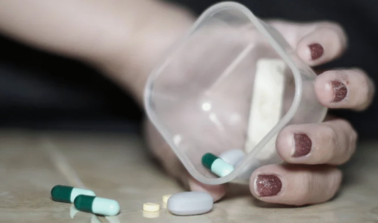 A person holding a box of pills