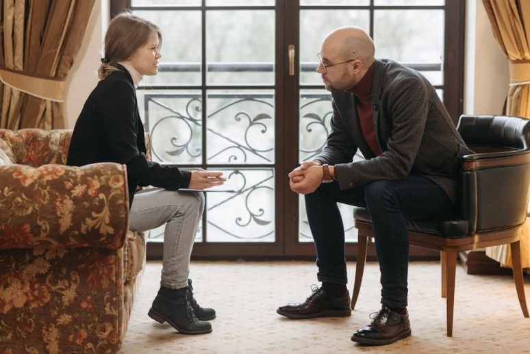 An image of two people talking  