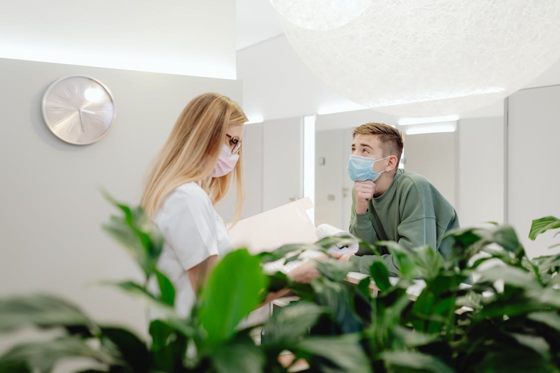 An image of a man talking to a woman over the counter