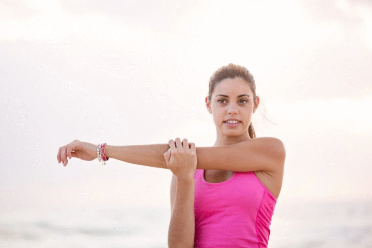 An image of a woman stretching her arms outdoors