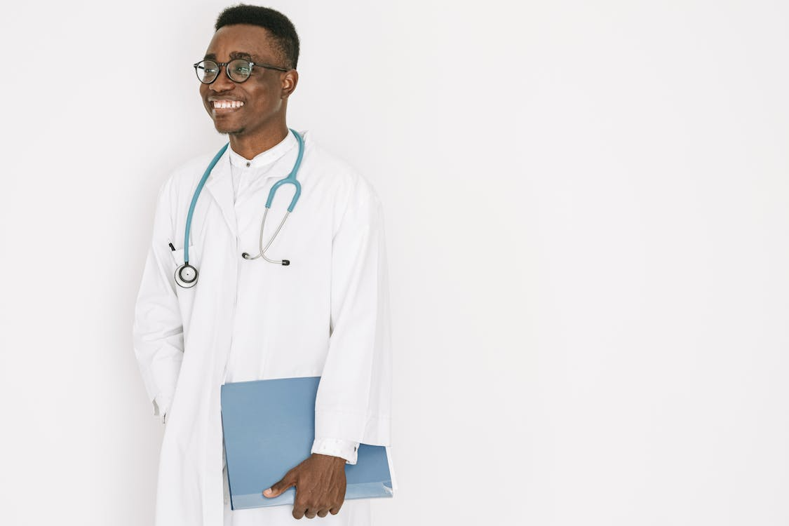 An image of a doctor with a file in his hand and a stethoscope around his neck