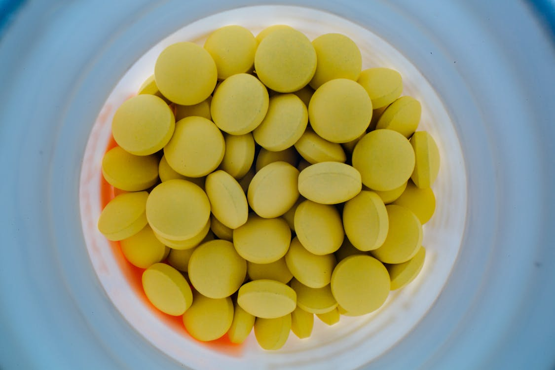 An image of yellow pills in a container
