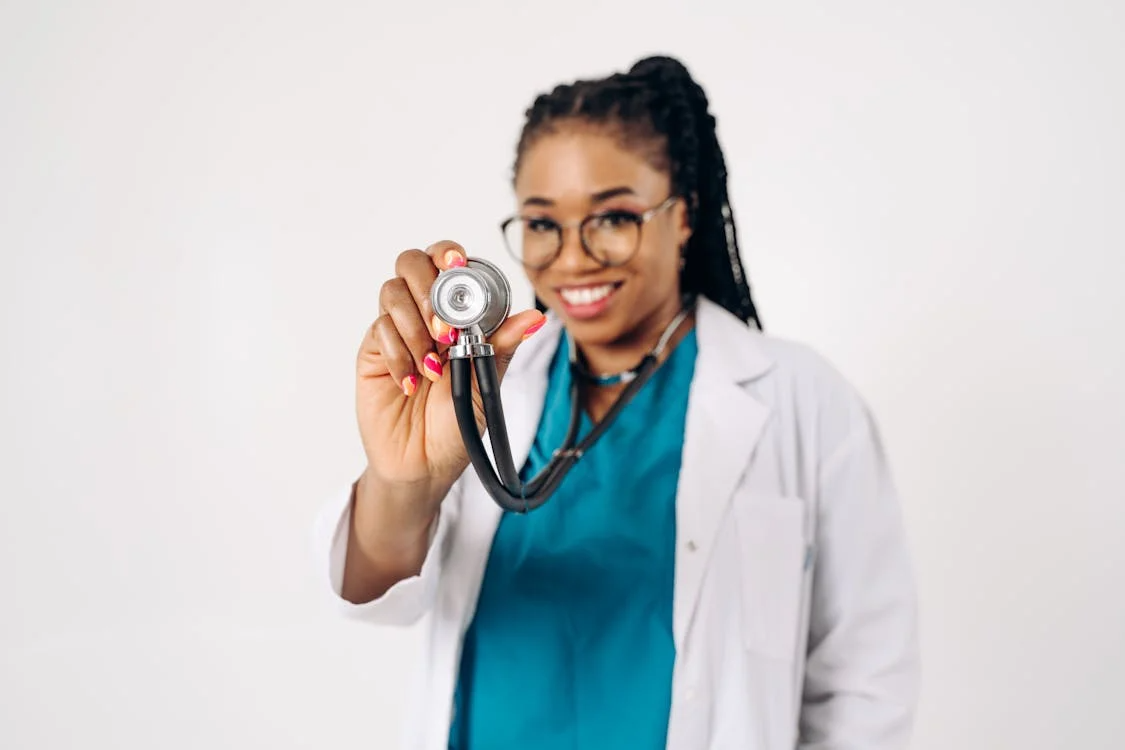 An image of a woman holding a stethoscope