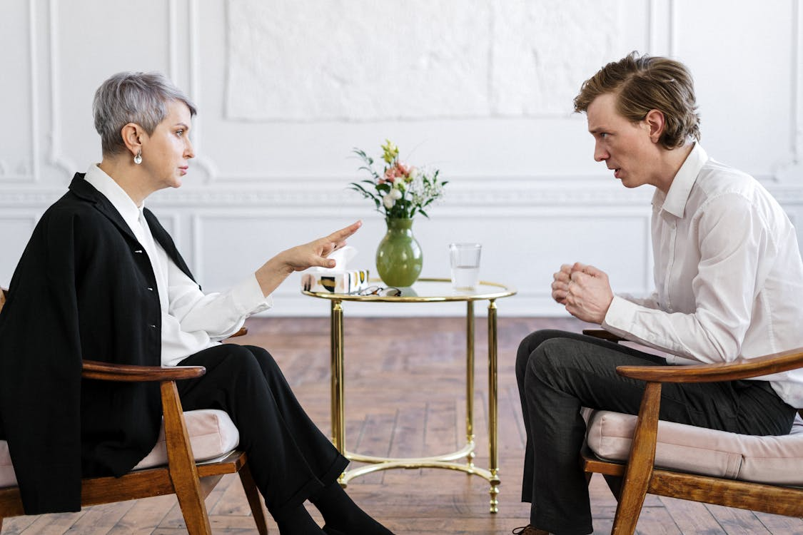 An image of a man talking to a therapist