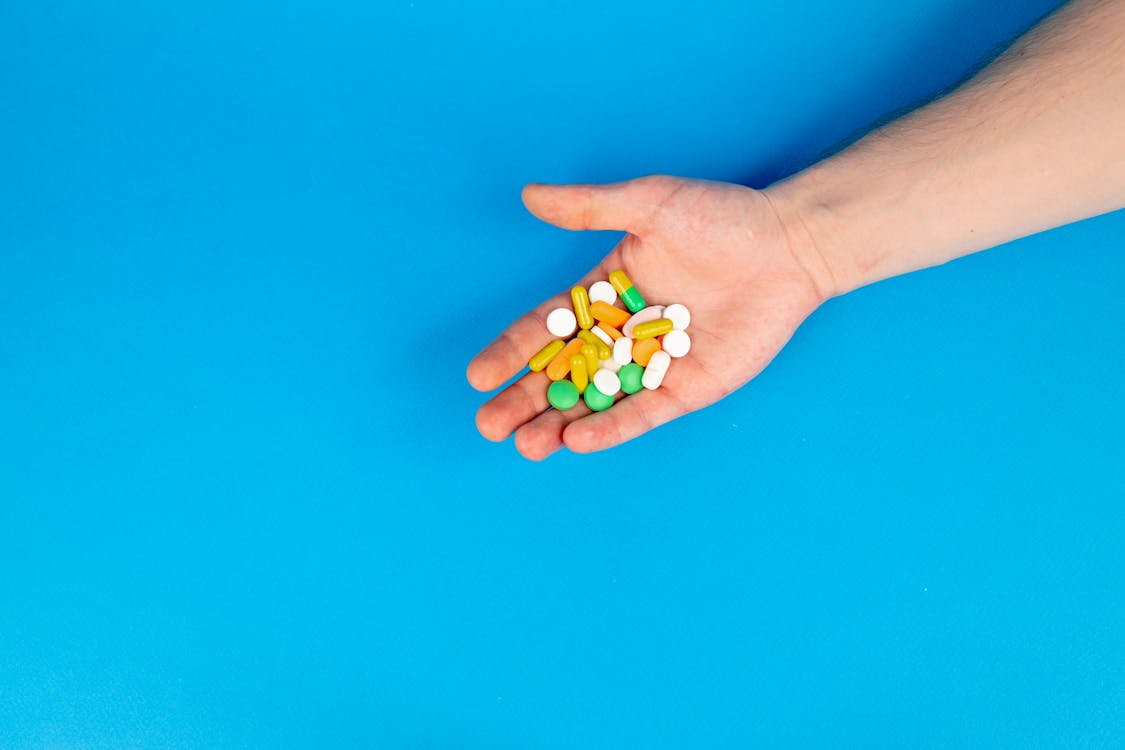 An image of an assortment of pills in a person’s hand