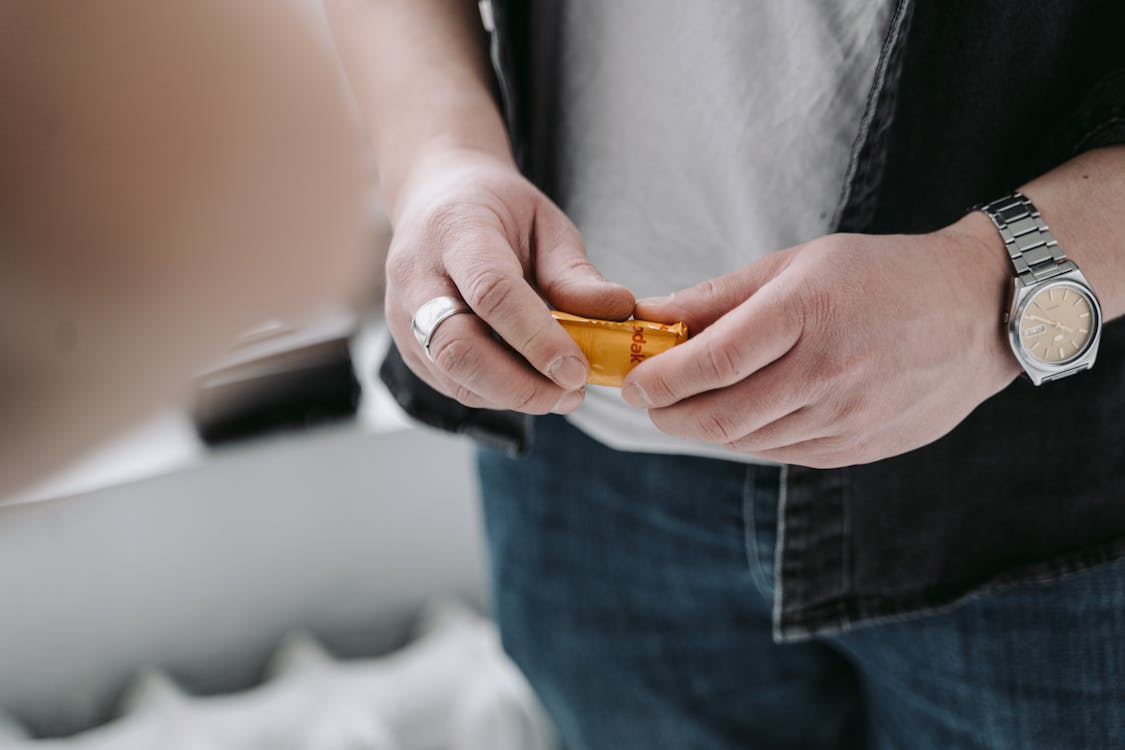 An image of green and white pills on a blue surface