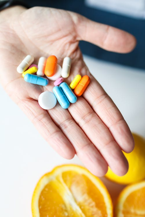 An image of an assortment of pills in a person’s hand