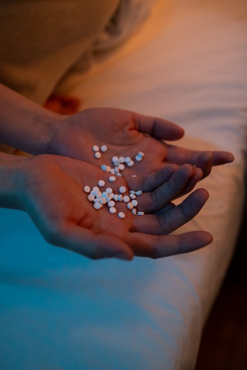 An image of an assortment of pills in a person’s hand