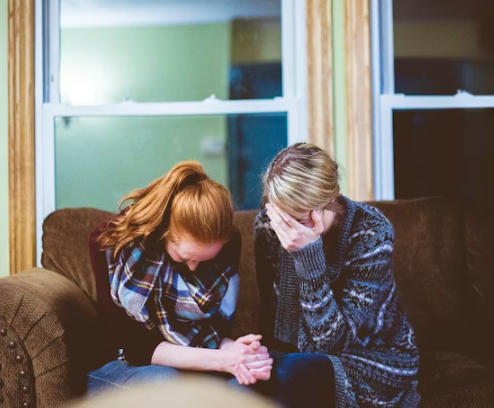 This image shows two individuals pausing together in quiet reflection.