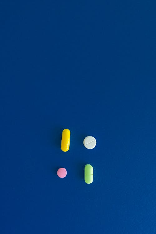An image of an assortment of pills on a blue surface