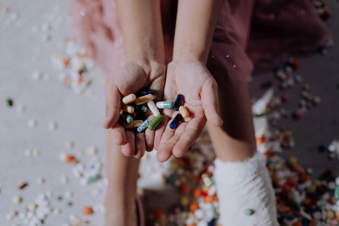 An image of an assortment of pills in a person’s hand