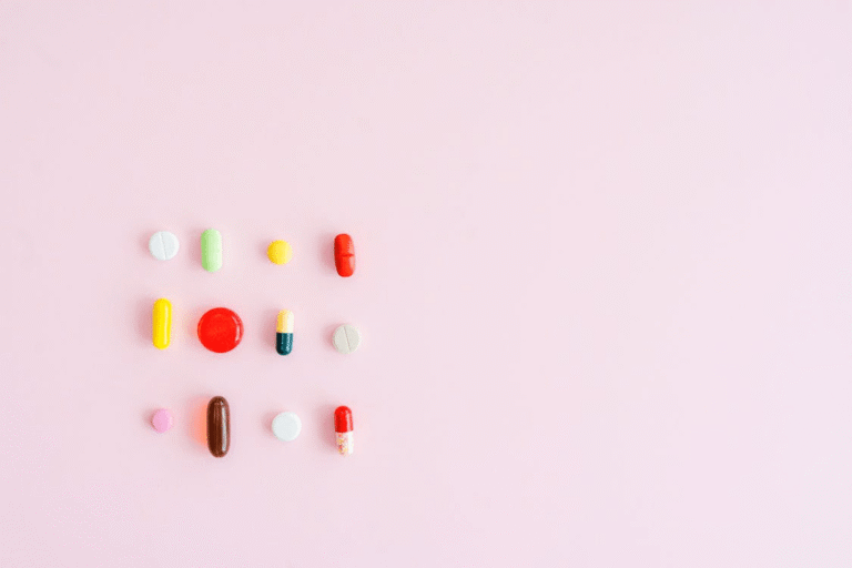 : An image of pills on a pink surface