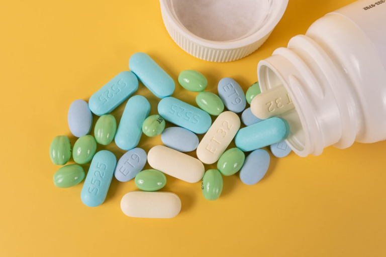 An image of an assortment of pills on a Yellow surface
