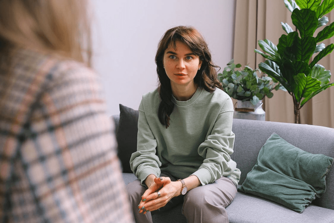 An image of a woman speaking to an addiction therapist