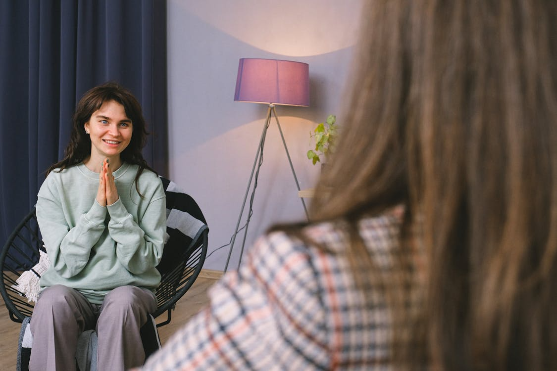 An image of a man speaking to an addiction therapist while lying down on a sofa
