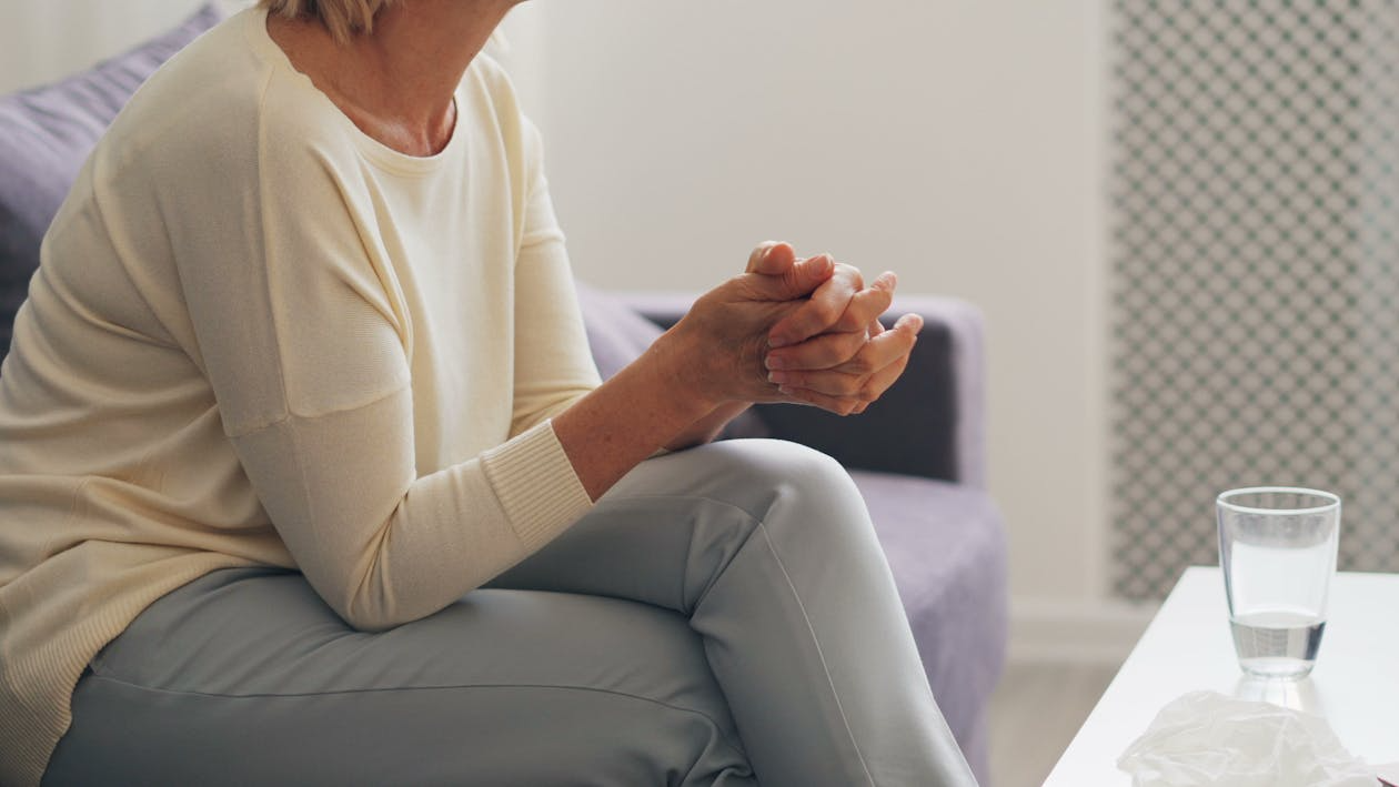 An image of a woman sitting on a sofa