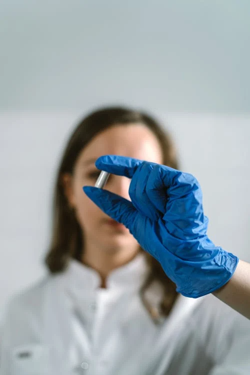 An image of a woman holding a pill