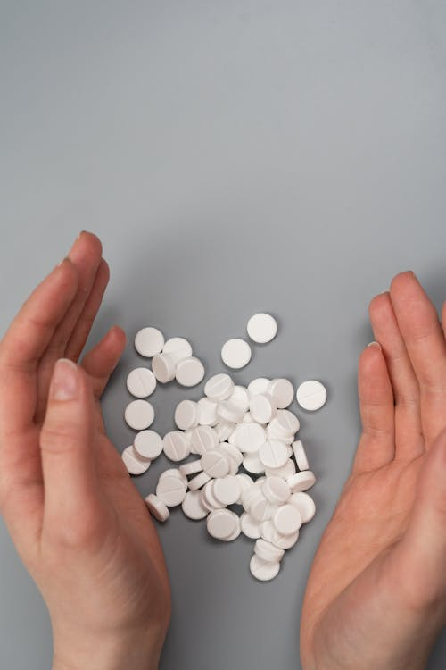 An image of white pills on a gray surface