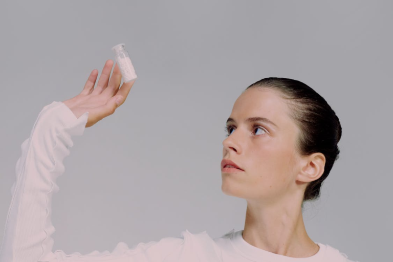 An image of a woman looking at pills in a bottle