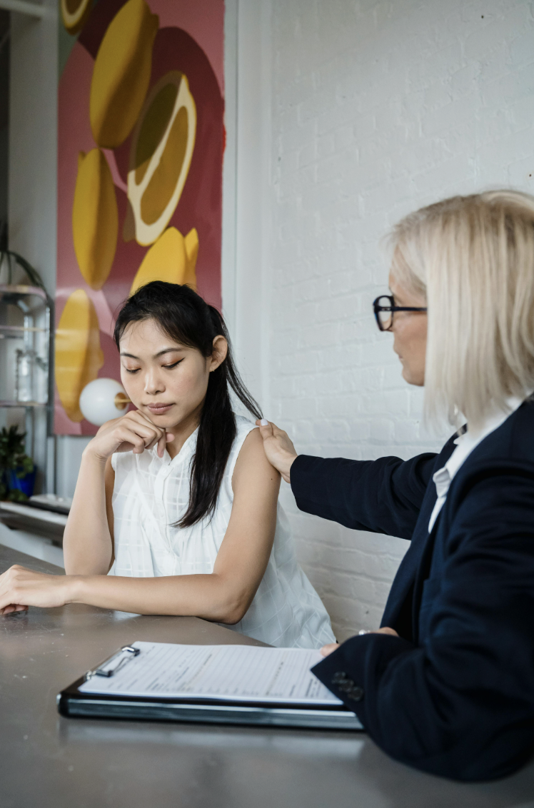 This photo shows two people in a supportive conversation together.