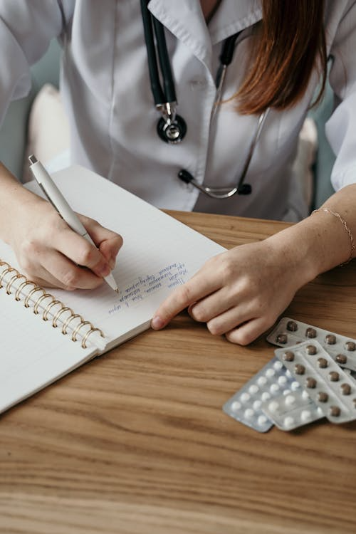 An image of a doctor writing in a notebook