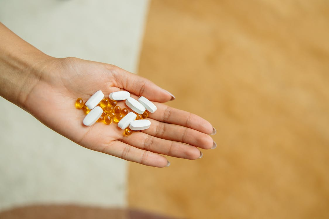 An image of pills in a person’s hand   