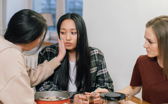 This image shows girls comforting a friend.