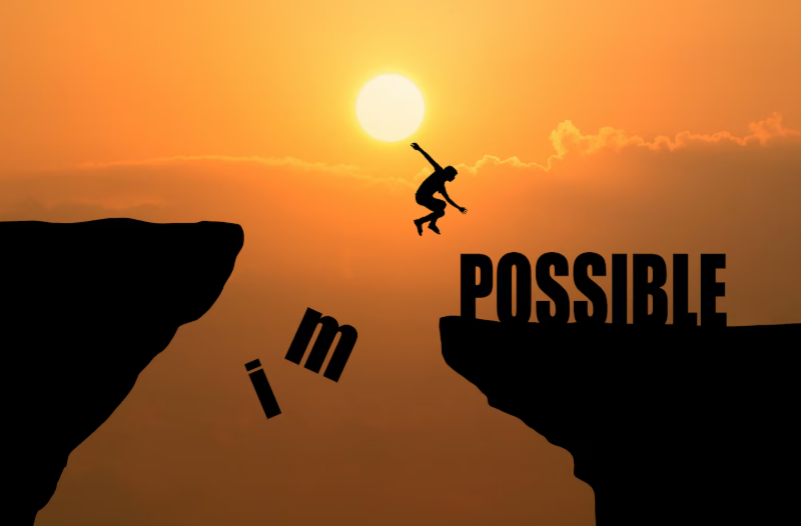 Man jumping across a cliff at sunset symbolizing overcoming challenges and turning setbacks into progress