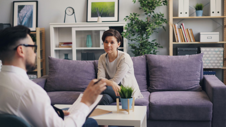 Therapist speaking with a patient during an addiction aftercare counseling session in a comfortable setting