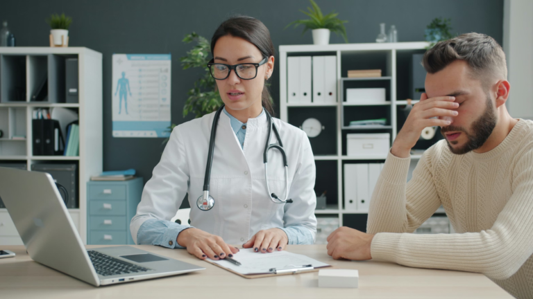 Doctor consulting with a distressed patient during early-stage opioid treatment in a clinical office