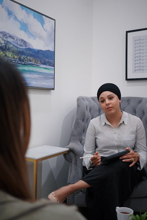 A woman speaking with a psychologist during a private therapy session